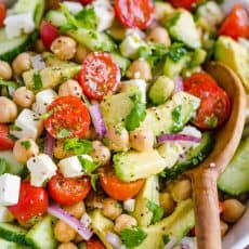 Chickpea Salad loaded with crisp cucumbers, juicy tomatoes, creamy avocado, feta cheese and chickpeas or garbanzo beans. Fresh, healthy and protein packed! #chickpeasalad #garbanzobeansalad #chickpeas #chickpeasaladrecipe #salad #saladrecipe #fetacheese #tomatosalad #avocadosalad #greeksalad #mediterraneansalad #natashaskitchen