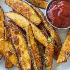 baked potato wedges on plate served with ketchup