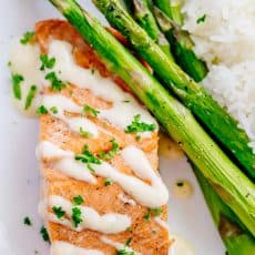 Oven Baked Salmon with flavorful and simple lemon cream sauce. Lemon beurre blanc, will be your secret weapon for seafood recipes. Gourmet flavors at home! | natashaskitchen.com