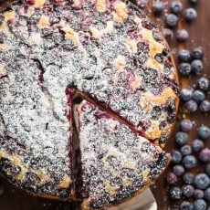 Lemon blueberry cake with slice being removed