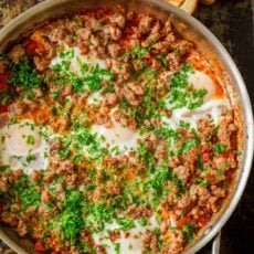 Shakshuka served in skillet with toasts