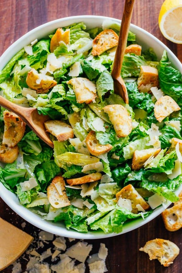How to Make Caesar Salad tossing with 2 spoons in a bowl