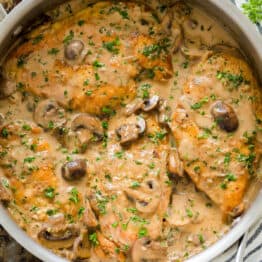 Finished Chicken Marsala Recipe topped with mushroom and parsley in a pan.