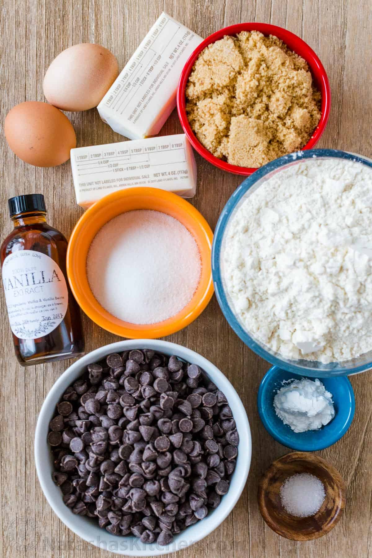 Ingredients for desserts with baking soda, brown sugar, chocolate morsals, butter and eggs