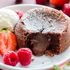 Chocolate Lava cake dusted with powdered sugar with molten center and served with ice cream and berries