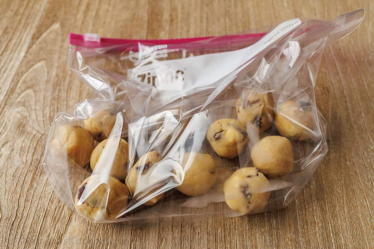 Frozen cookie dough balls in a freezer safe ziploc bag