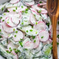 CLASSIC! Cucumber Radish Salad with a simple sour cream dressing. Did you know radishes are a superfood? One of our all-time favorite radish recipes. | natashaskitchen.com