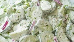 creamy cucumber salad recipe with crispy cucumbers, tangy red onions and delicious sour cream dressing