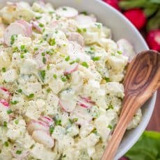 The most flavorful creamy potato salad recipe! This potato salad is loaded with fresh cucumber and radish - lighter and satisfying! Excellent and easy potato salad recipe | natashaskitchen.com #potatosalad #potatosaladrecipe #howtomakepotatosalad #potatoes