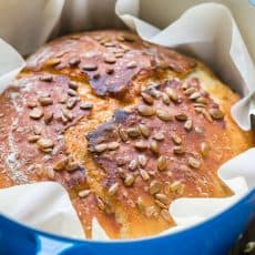 Loaf of bread baked in a dutch oven to make dutch oven bread covered with seeds