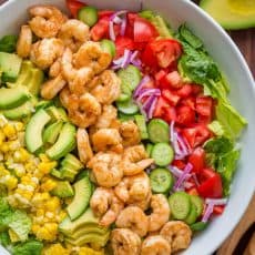Shrimp Cobb Salad with a chopped romaine base layered with shrimp, avocado, and tomatoes