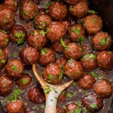 Grape jelly Meatballs in slow cooker with serving spoon