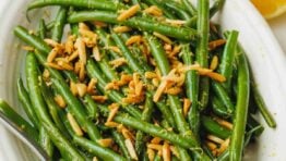 green beans with almonds for thanksgiving in a white dish