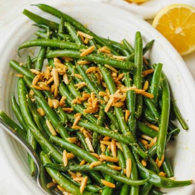green beans with almonds for thanksgiving in a white dish