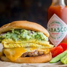 Spicy guacamole brunch sandwich with a crisp toasted bun, juicy sausage, melty cheese, fluffy eggs and guacamole! Easy guacamole breakfast sandwich! | natashaskitchen.com
