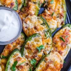 Jalapeno poppers arranged on tray with ranch