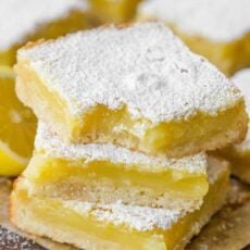 Lemon bars stacked and dusted with sugar