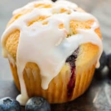Blueberry Muffins with lemon glaze and fresh blueberries scattered