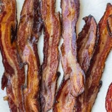 Crispy Oven Baked Bacon on paper towel lined plate