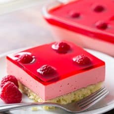 Raspberry Jello Cake Recipe - Perfect for parties and potlucks and it's kid-friendly! (Video Recipe Included) @natashaskitchen