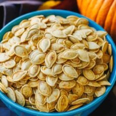Roasted pumpkin seeds in a large blue bowl