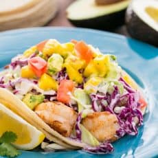 These Shrimp Tacos with Coconut Coleslaw & Mango Salsa are a yummy mouthful. Inspired by the famous fish tacos at Coconut's Fish Cafe in Maui.