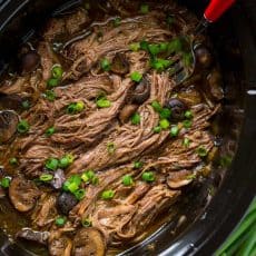 Slow Cooker Beef Brisket is fall-apart tender, juicy, flavorful and easy! The only Slow Cooked beef brisket recipe you'll need! Serve as a side or in a bun. | natashaskitchen.com