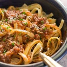 Good bolognese sauce (Italian Ragu) is cooked slowly, puttering away as deep meaty flavors develop. This slow cooker bolognese recipe couldn't be easier! | natashaskitchen.com