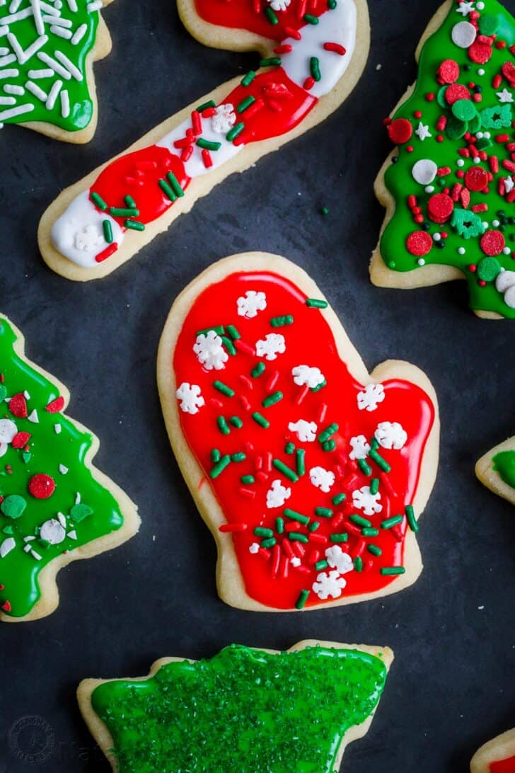 Sugar cookies decorated with frosting and festive holiday sprinkles