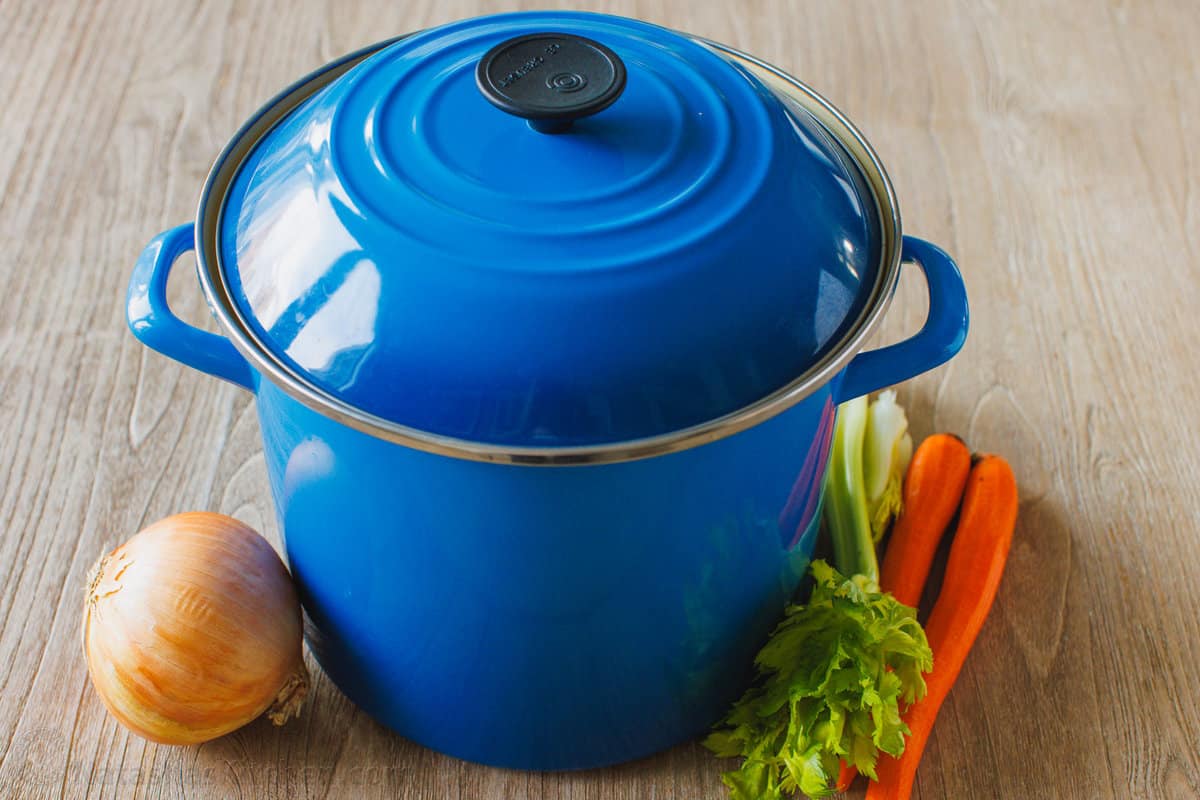 A large pot used for making bone broth with carrots, celery and onions
