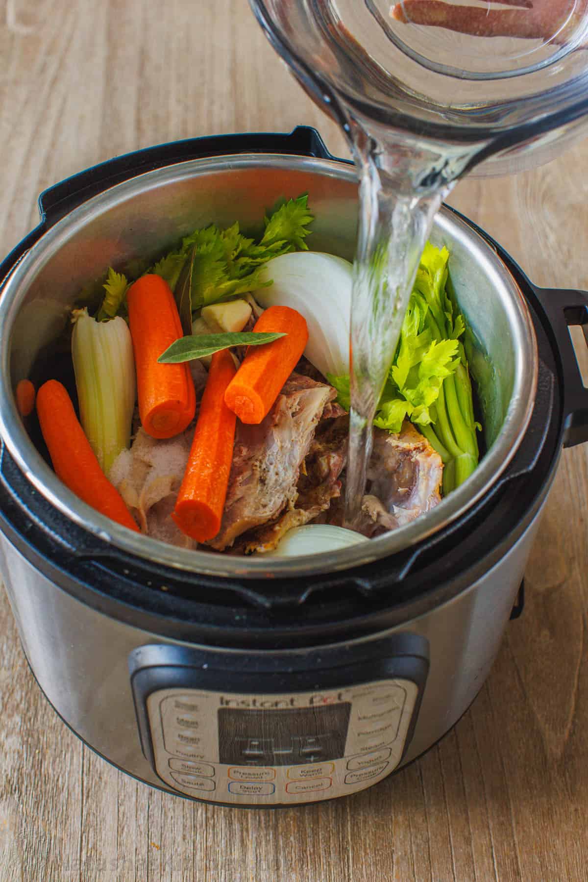 Instant Pot turkey stock recipe with carrots, onion, celery and turkey bones