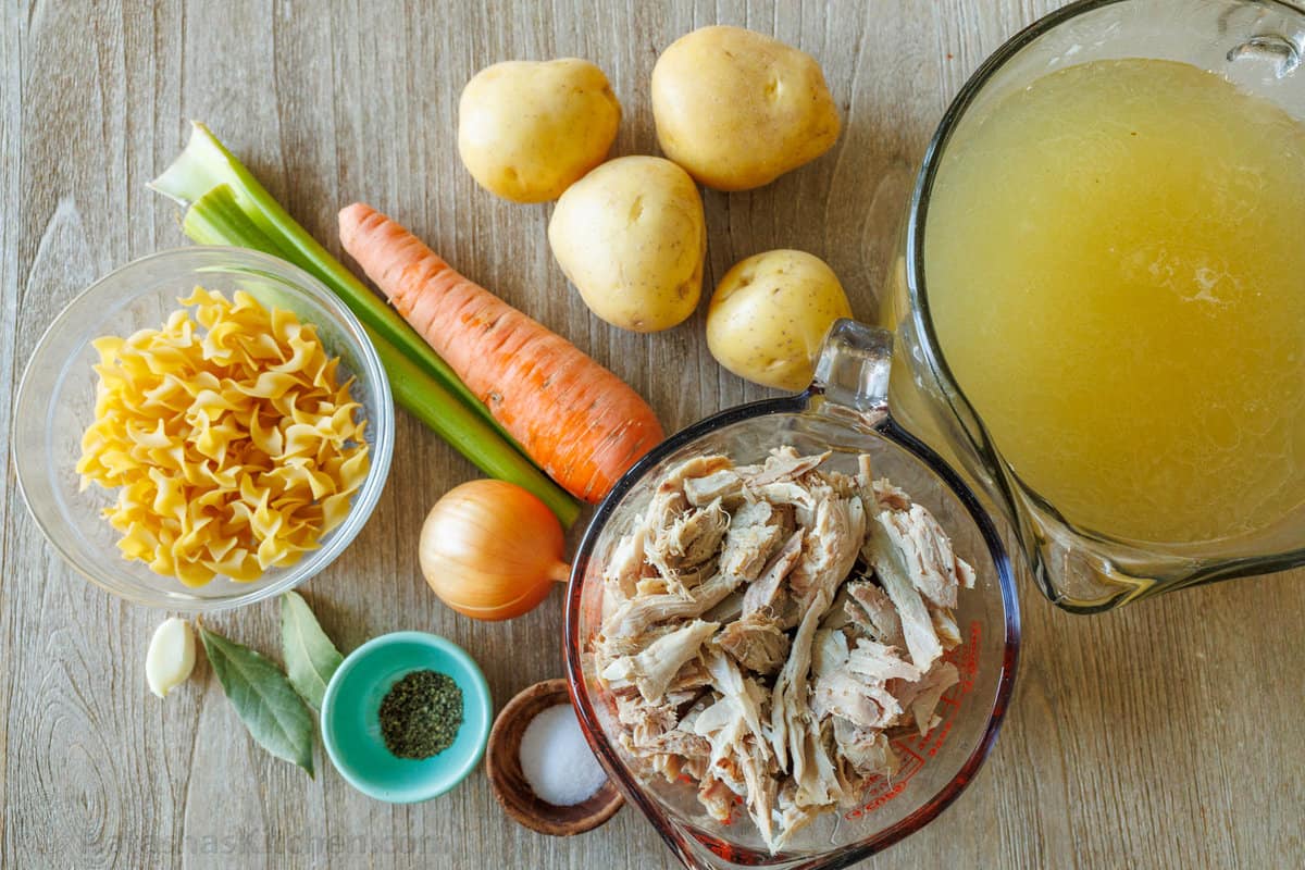 Ingredients for turkey soup carrot, turkey, potatoes, garlic, turkey broth, salt and pepper, egg noodle pasta, onion, bay leaf