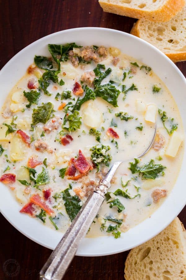 Zuppa toscana copycat recipes in bowl with spoon and served with bread